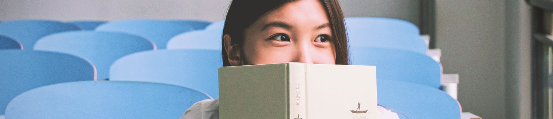 Girl with book in auditorium